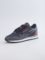 Navy blue sneaker with red accents on a light gray background